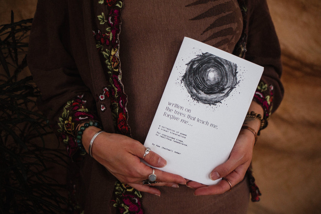 Rachael Amber holds limited first edition poetry booklet "written on the trees that teach me, forgive me..."
